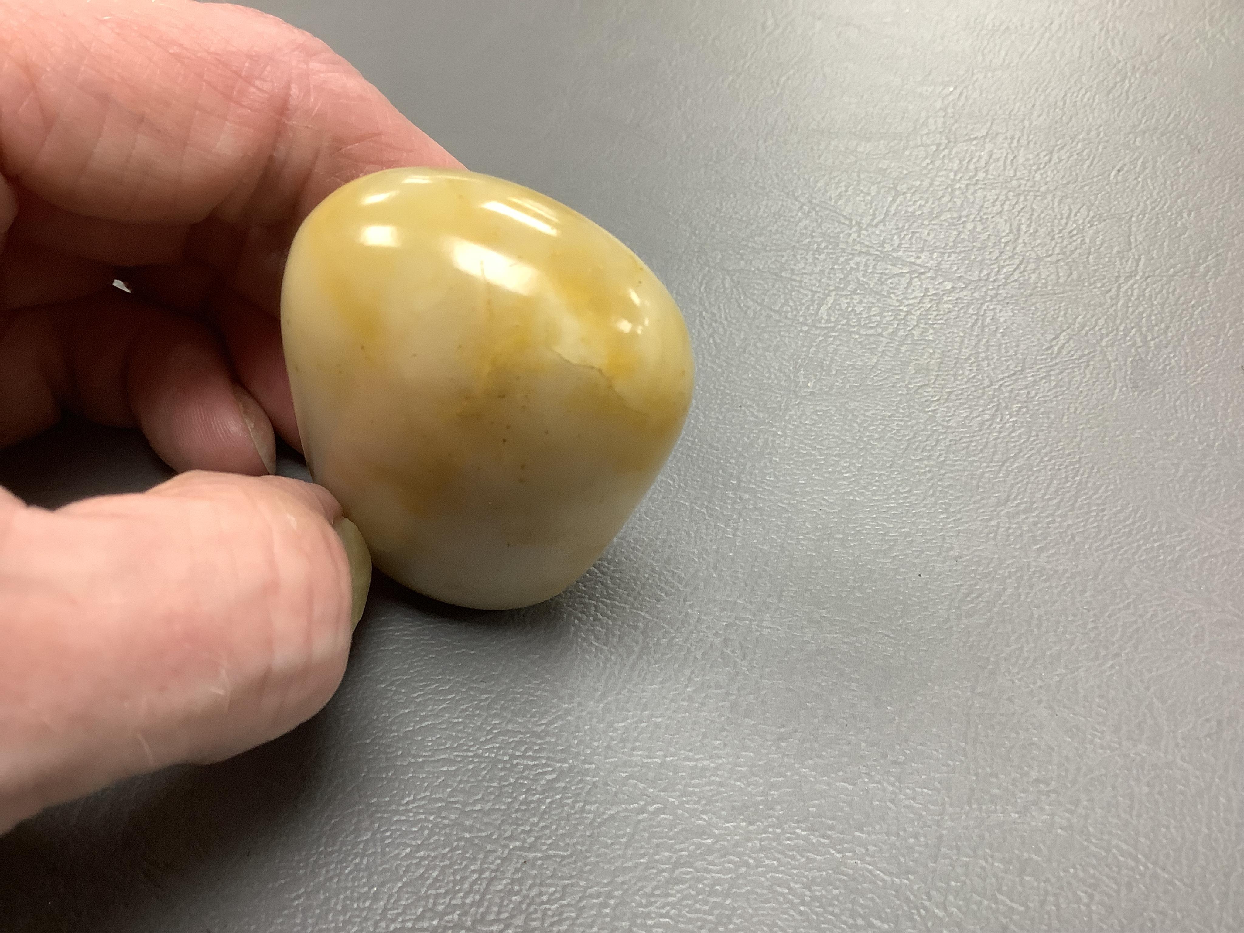 A 19th century Chinese white and russet jade pebble snuff bottle, 5.5cm in length